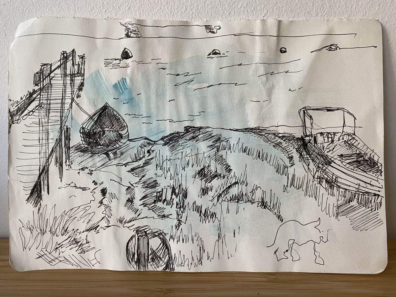 Pen sketch of a beach scene with a boat, jetty and dune grass.